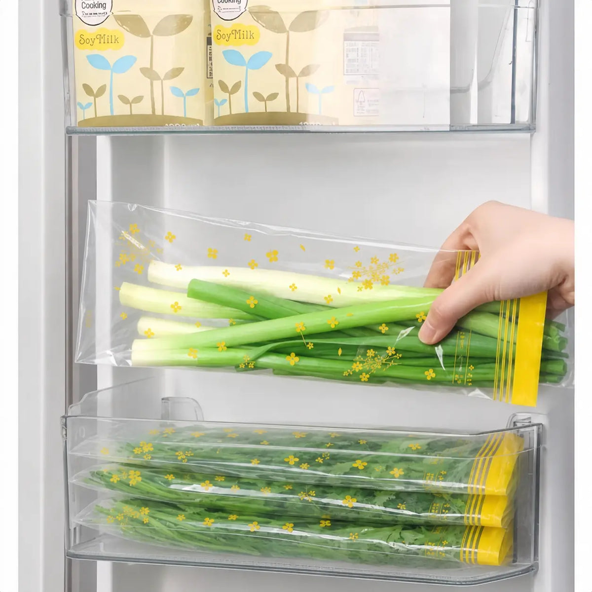 Reusable produce storage bags organized inside a refrigerator drawer